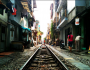 Train squeezes through Hanoi Featured Image