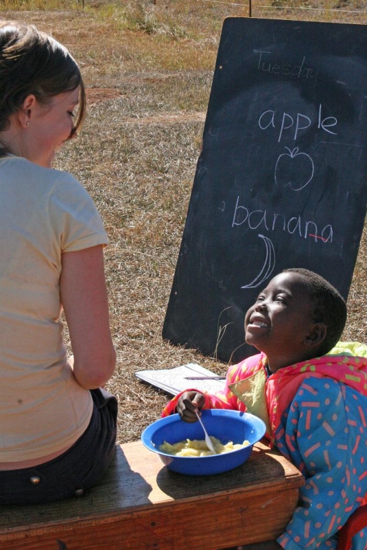 Volunteer & orphaned child at care center