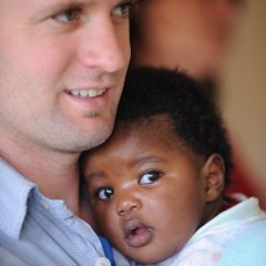 Volunteer holding a baby