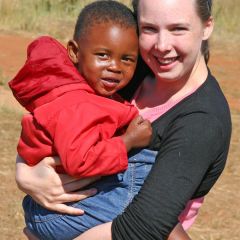 Volunteer hugging orphaned child
