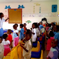 Disadvantaged children singing at Place of Joy day